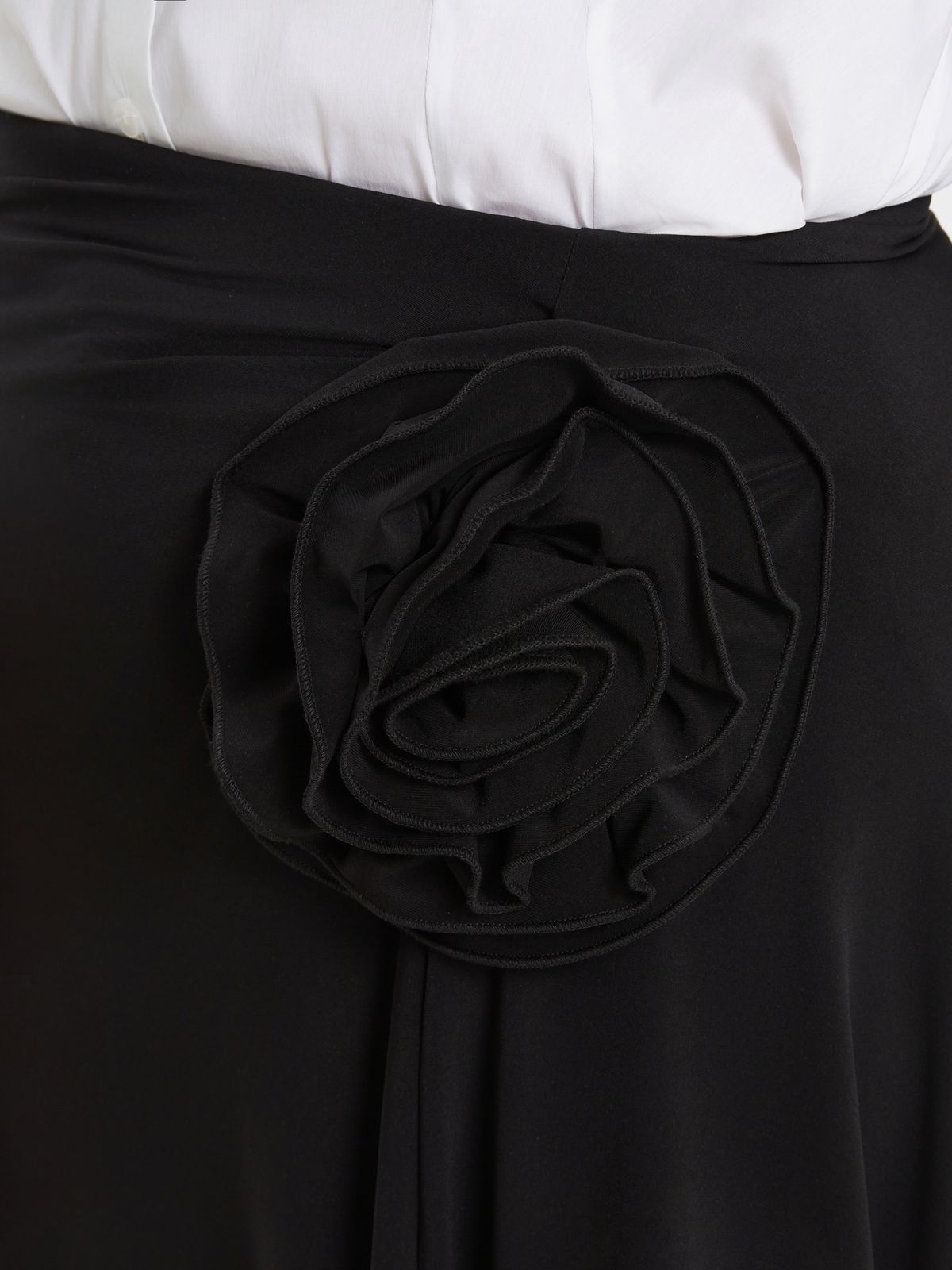 Black asymmetric skirt with floral detail and draped hem