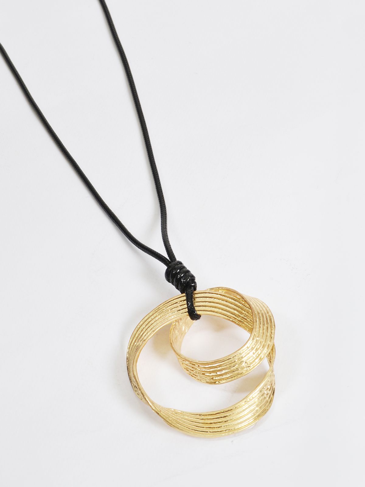 Textured metal pendant necklace on adjustable cord