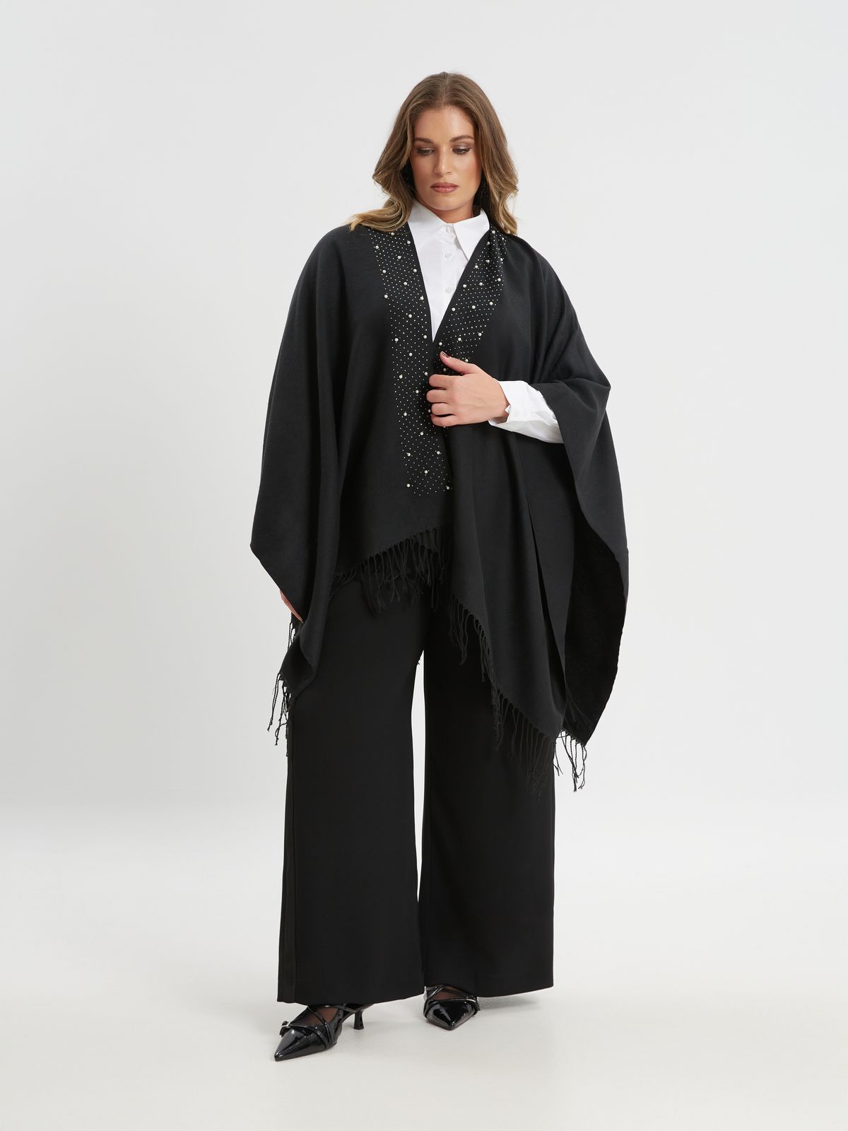 Black cape with pearl detail and fringe