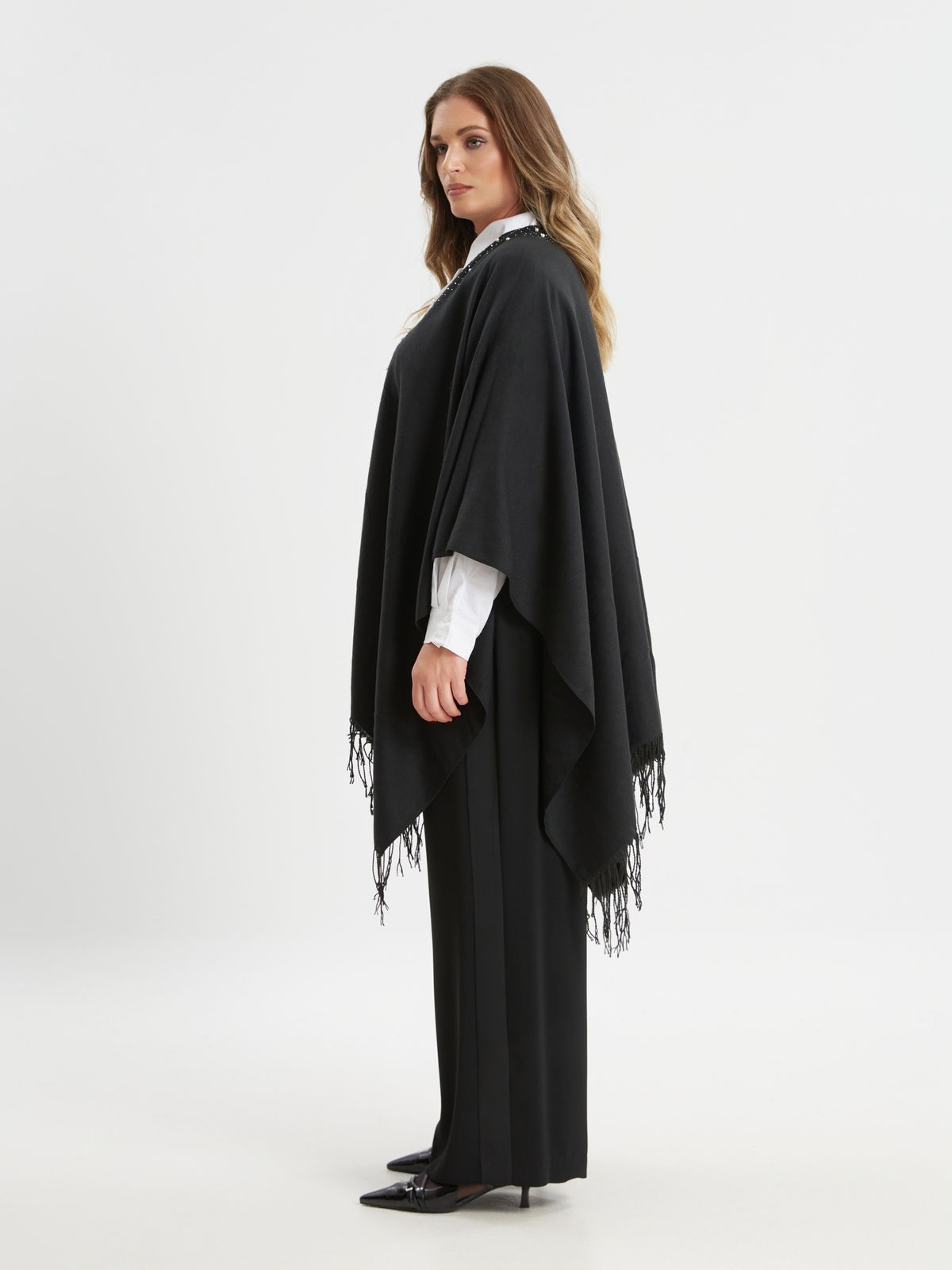 Black cape with pearl detail and fringe