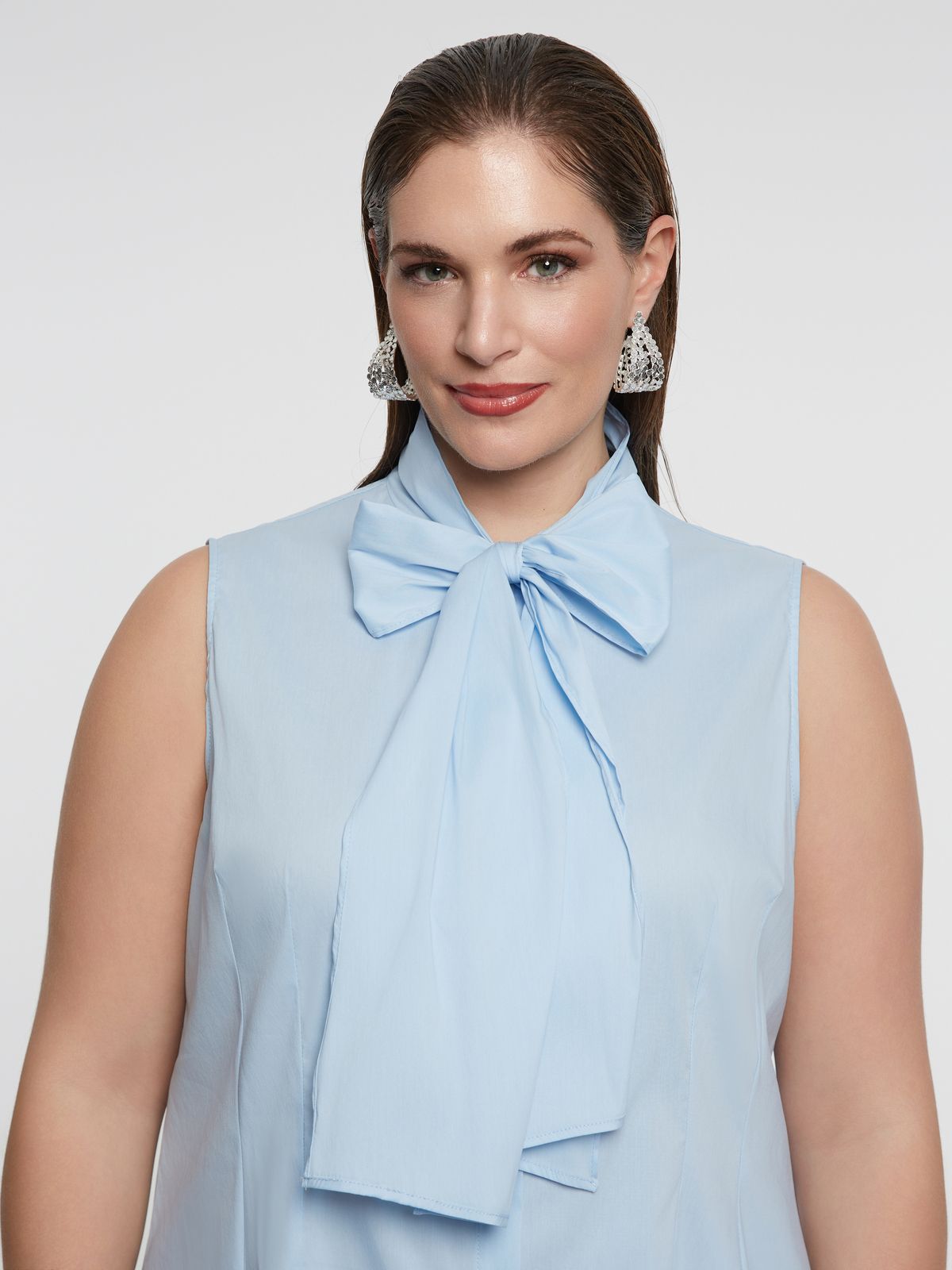 Sleeveless button-down blouse with bow detail