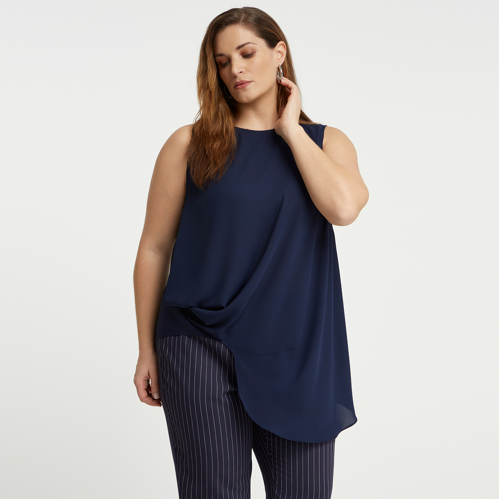 Sleeveless crepe top with asymmetrical hem